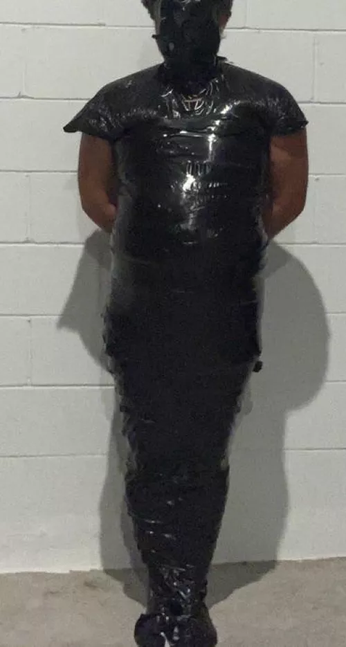 Mummified in trash bags and black tape