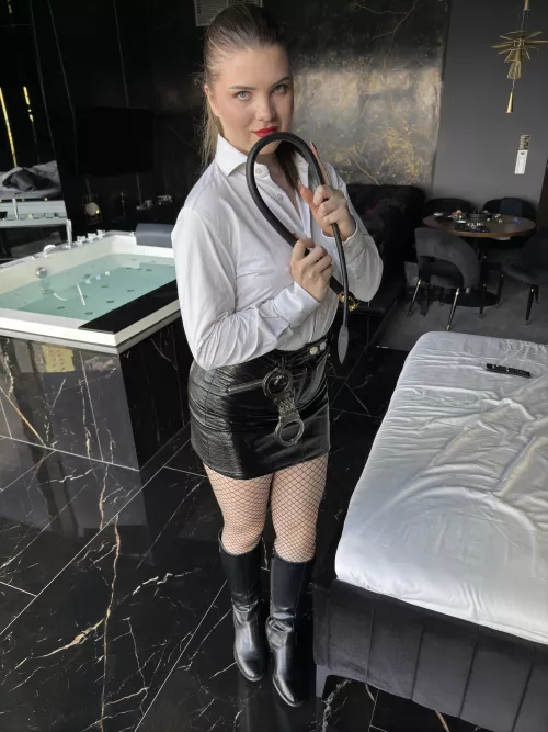 domina in leather mini skirt