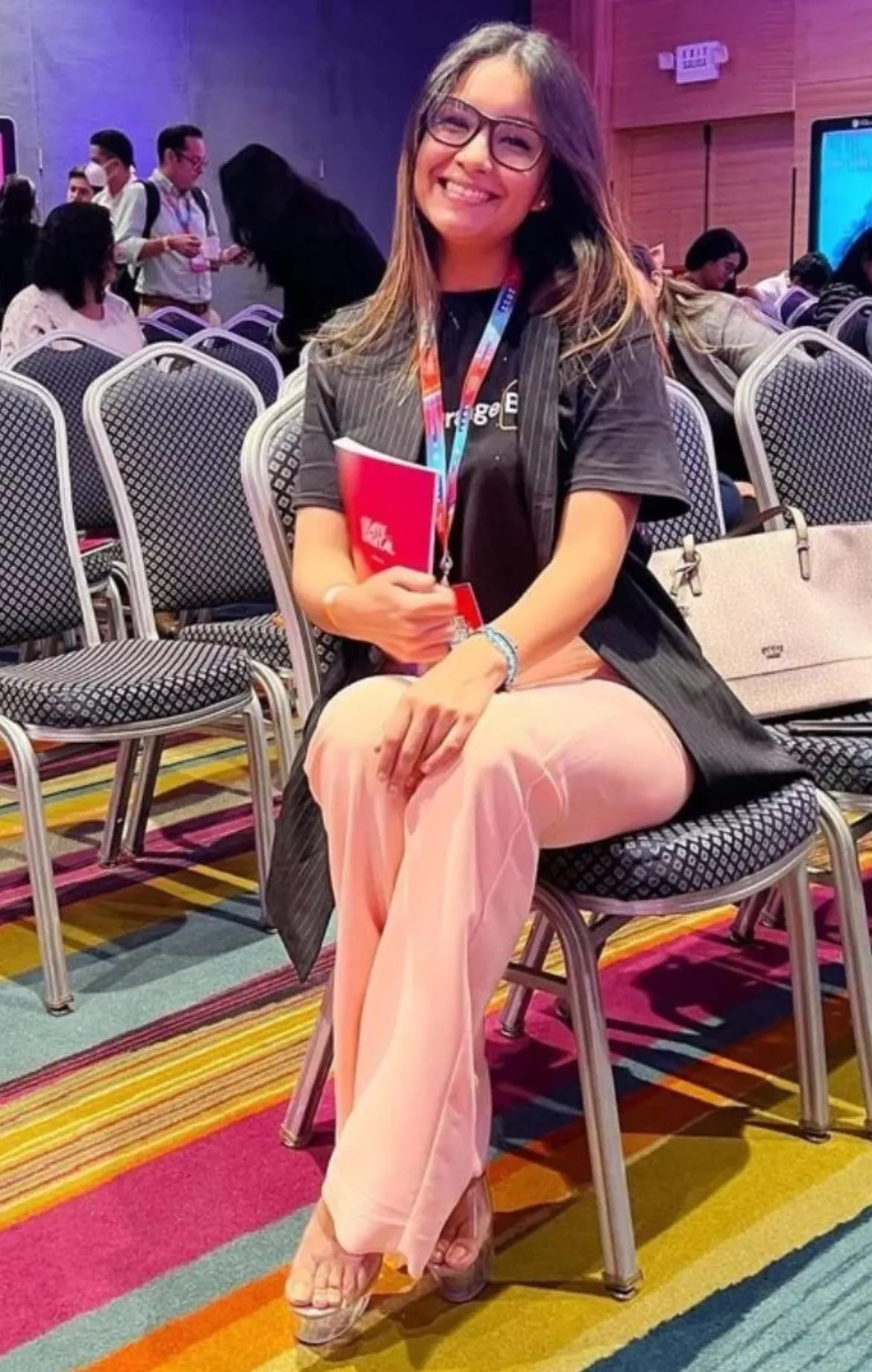 Casually wearing her clear stripper heels at a conference 