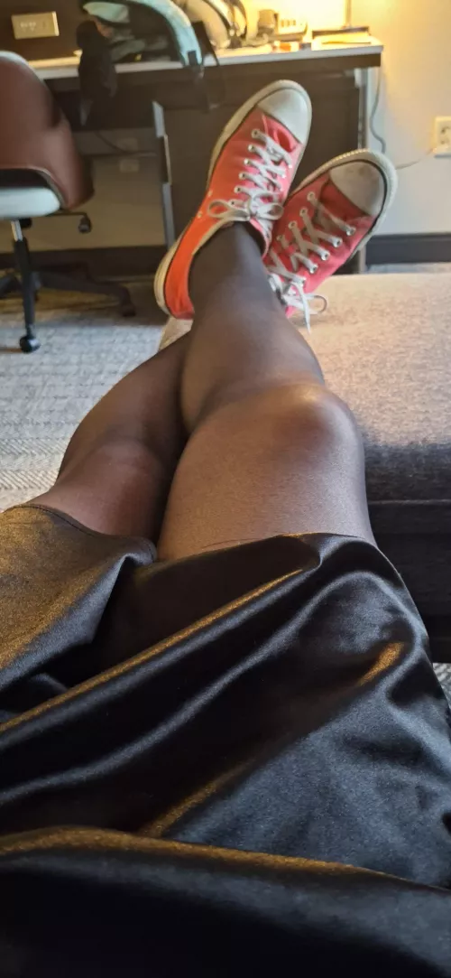 Satin skirt, black pantyhose, pink converse.
