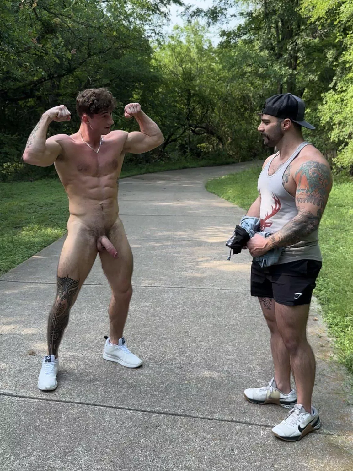 Stripping down and flexing while another guy watches 