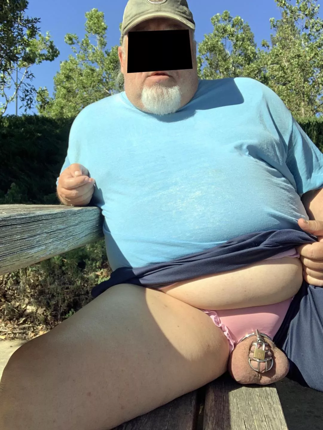 New here. Caged balls casually resting on a park picnic bench.