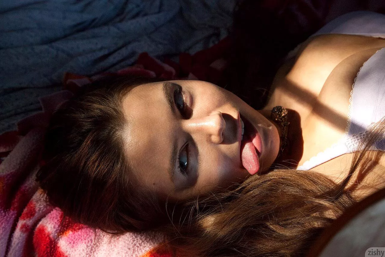 Sticking out her tongue 