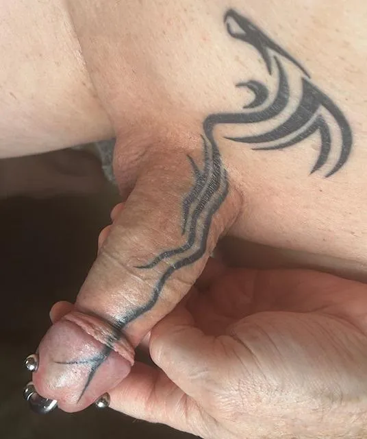 Pubic dragon tattoo extended down the shaft and onto the head