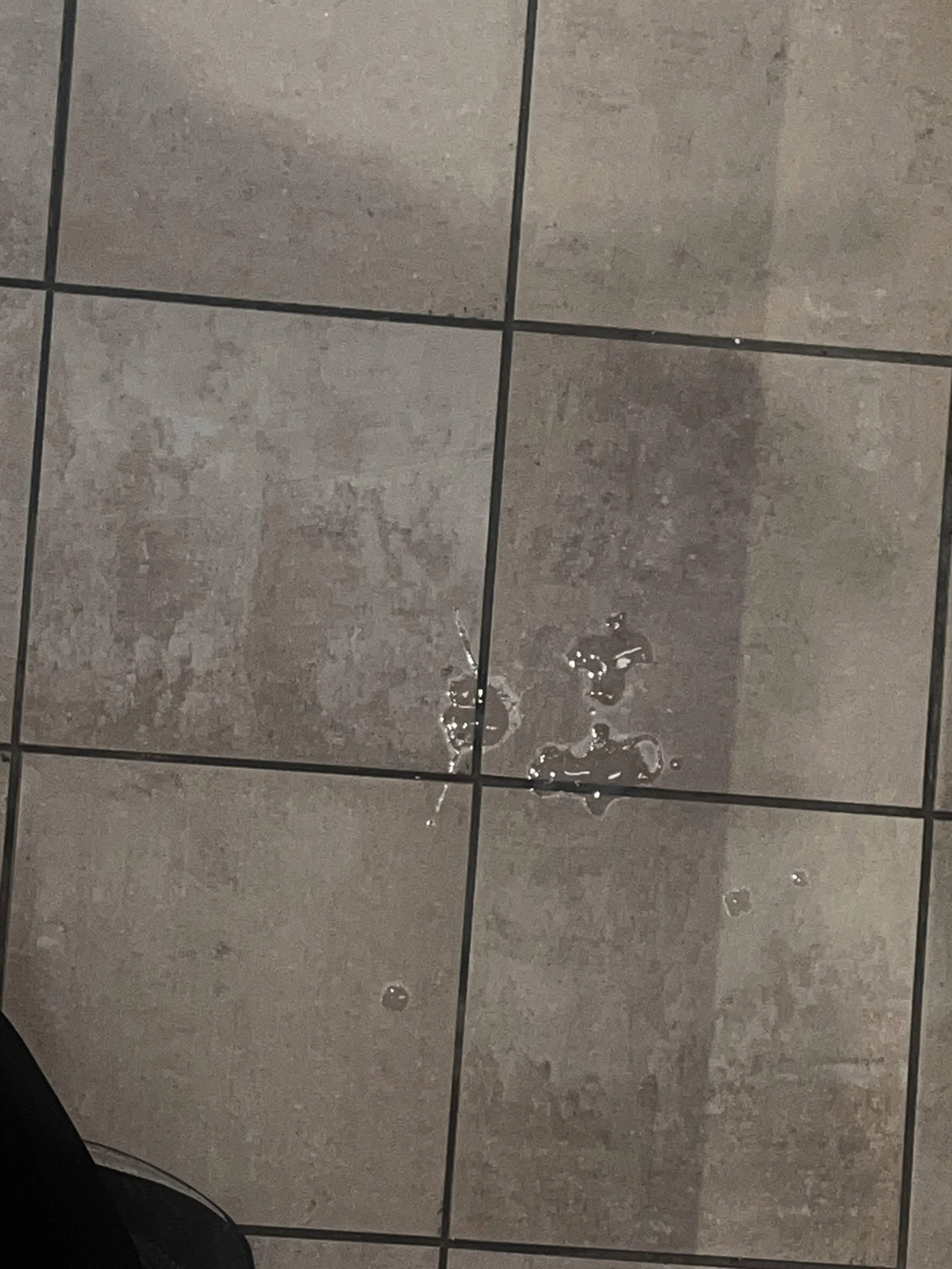 (32) cum tagged floor at a convention center bathroom.