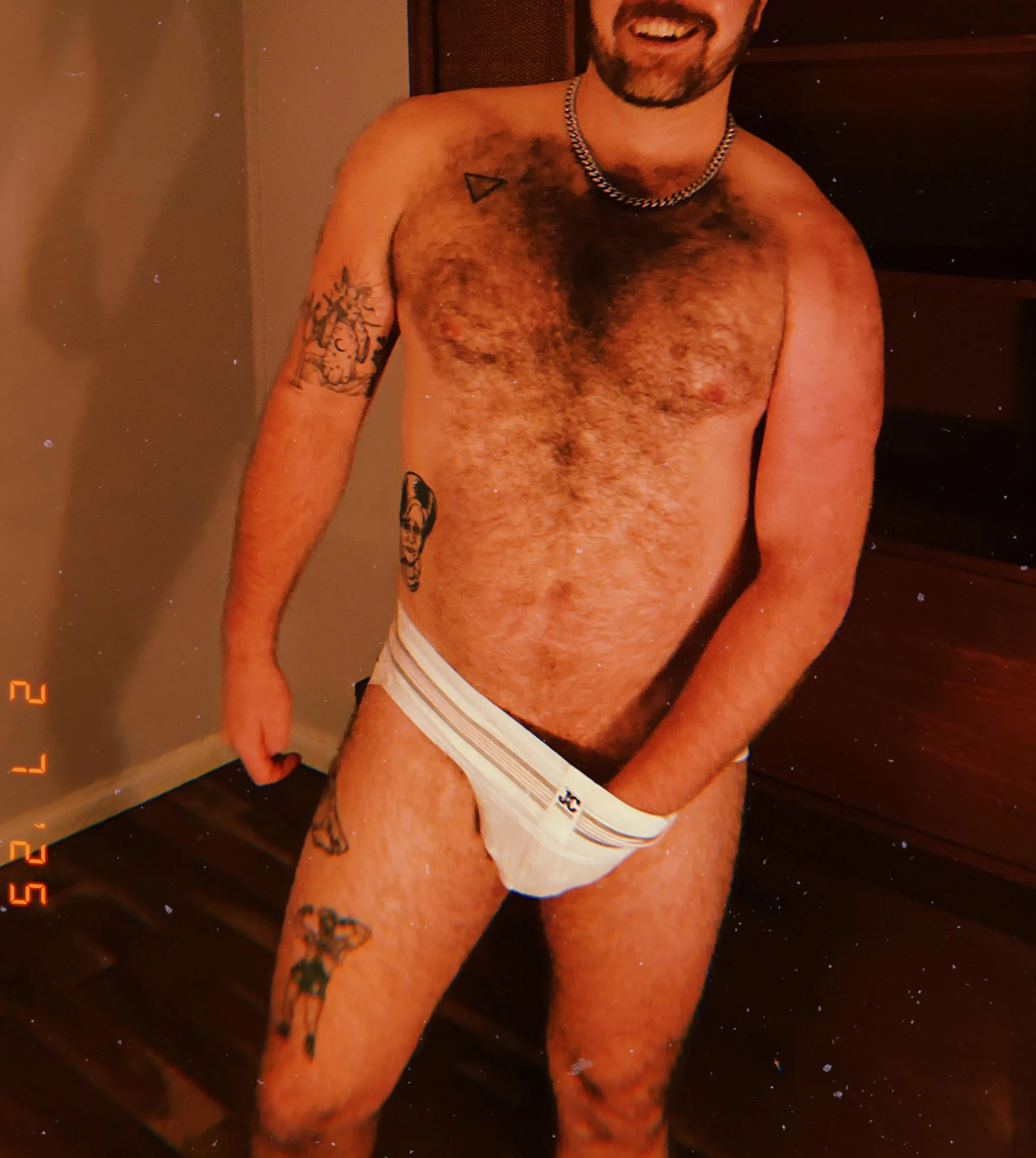 All smiles and chest hair.