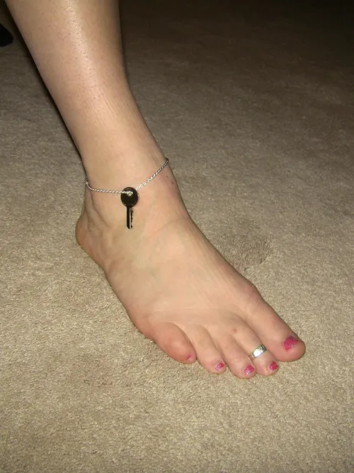 Cute feet, nice manicure, toe ring and hubby's chastity key securely around my ankle. 
