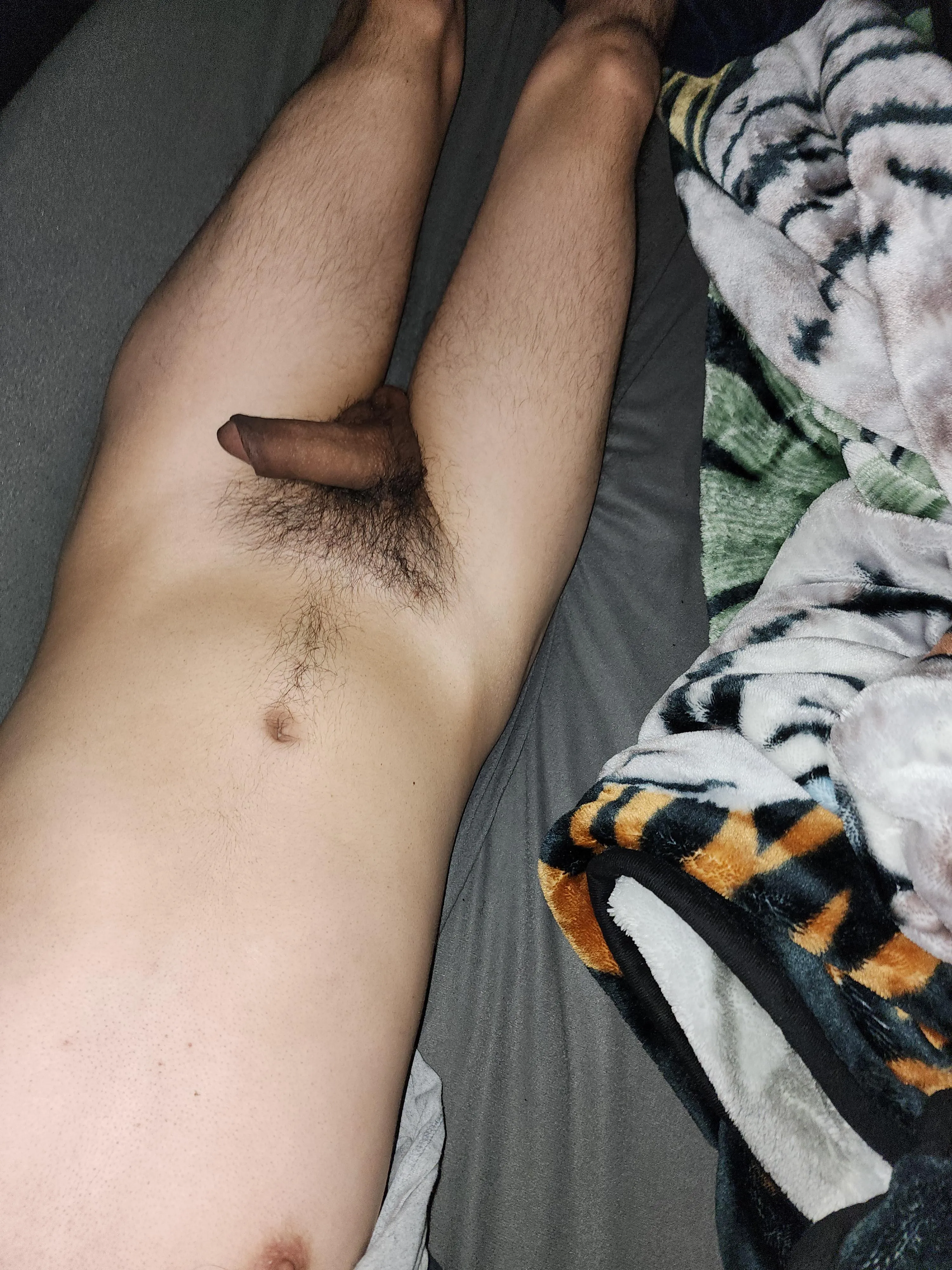 Relaxing nude in bed.