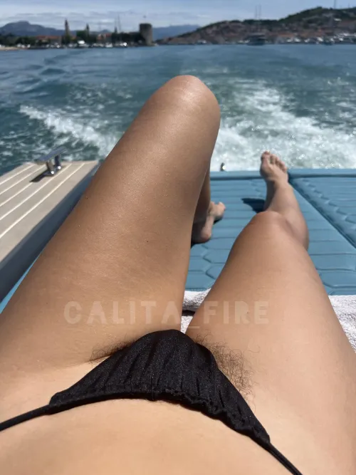 Black thong bikini, sun-kissed skin and a view worth fantasizing about