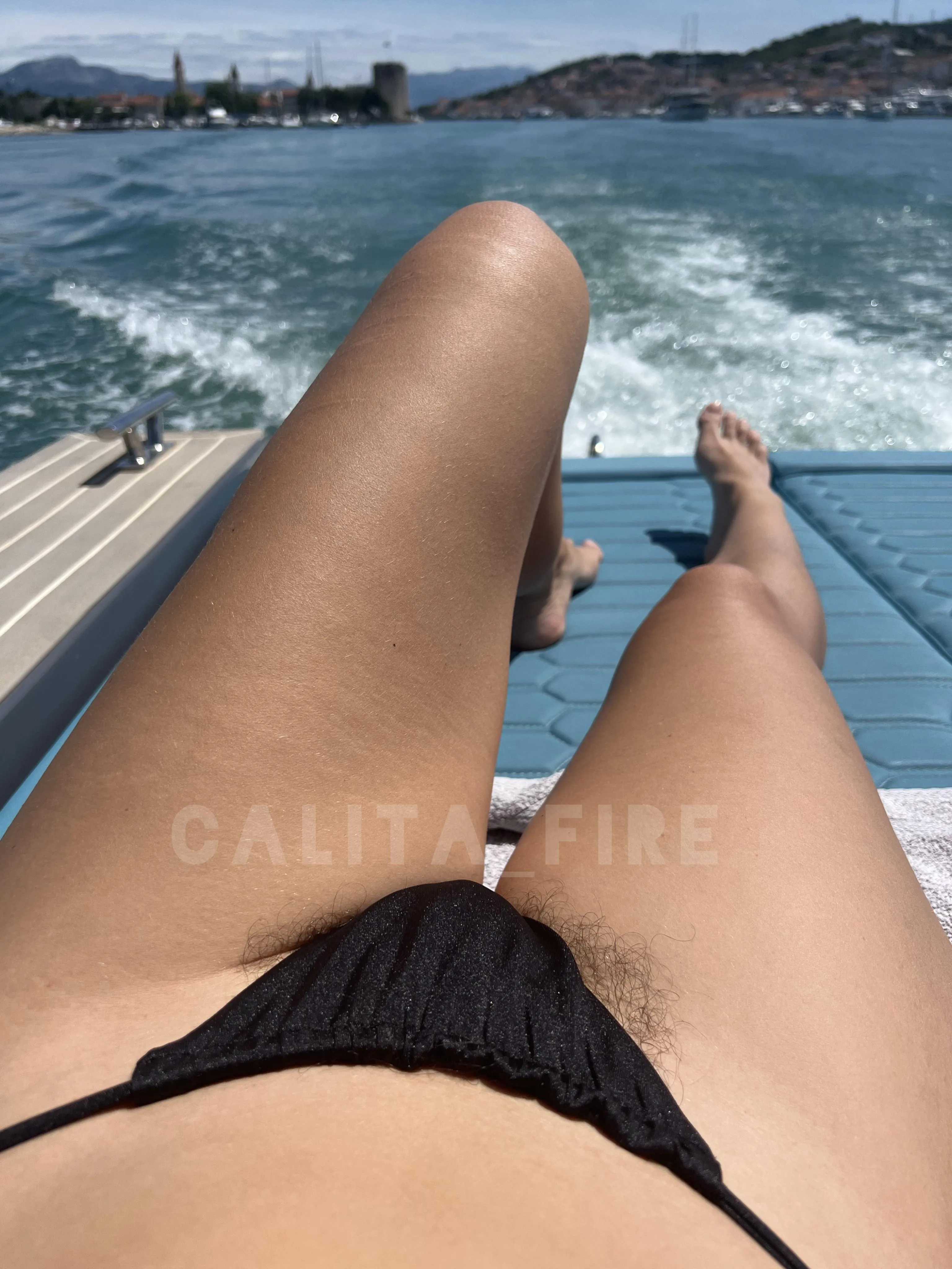 Black thong bikini, sun-kissed skin and a view worth fantasizing about
