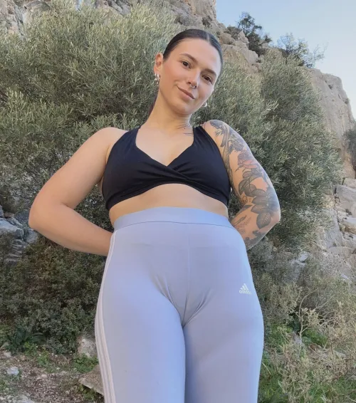 Smiling tattooed babe with nose piercing shows off her camel paw