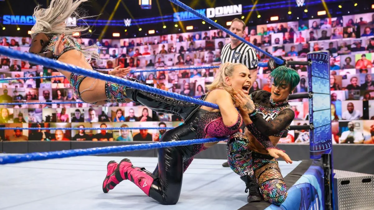 Poor Natalya struggling helplessly against Ruby And Liv
