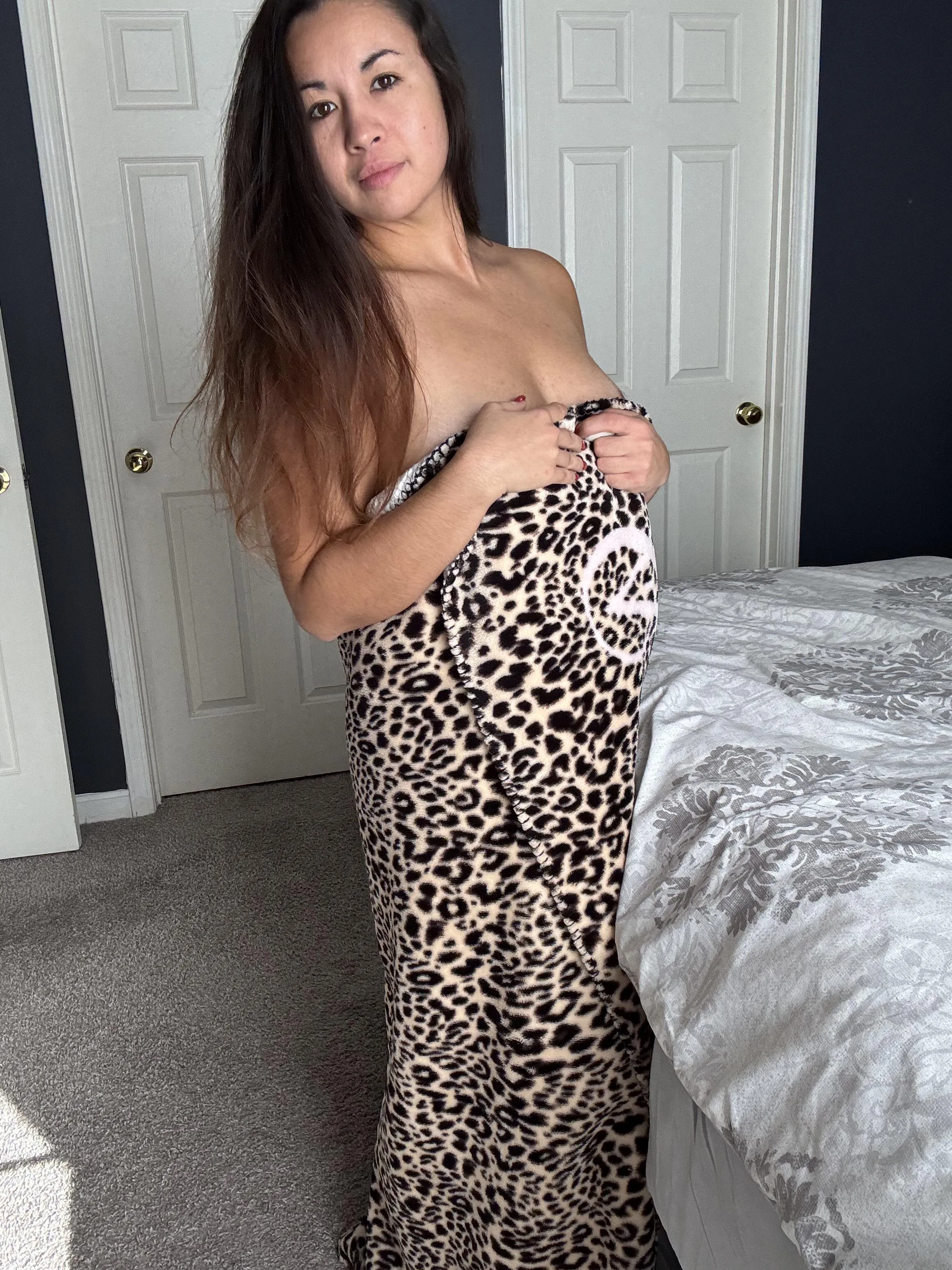 Wrapped up in a fuzzy leopard print blanket.
