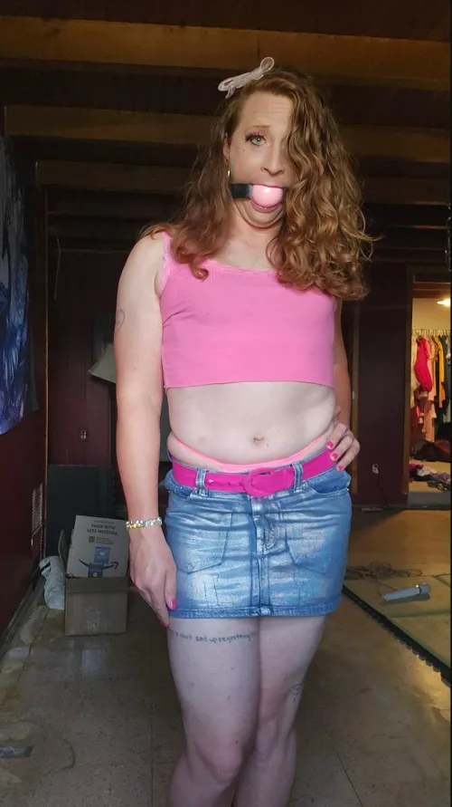 Ballgagged redhead in a miniskirt.
