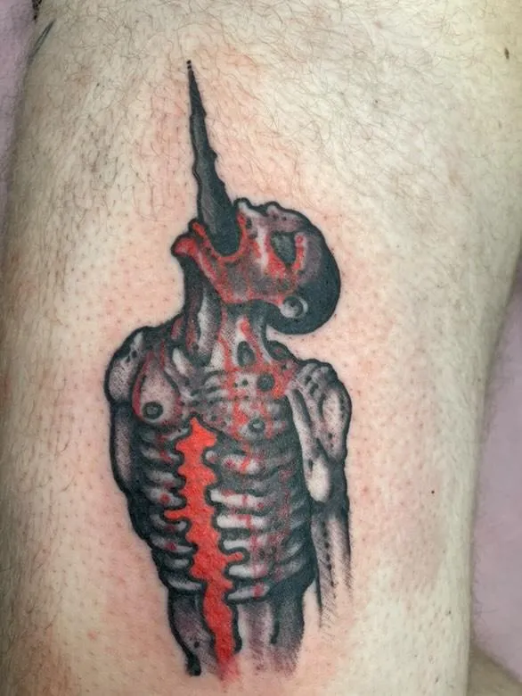 Grotesque impalement tattoo