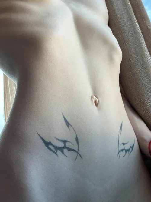 A sweet  view of my womb tattoos on my slender tummy