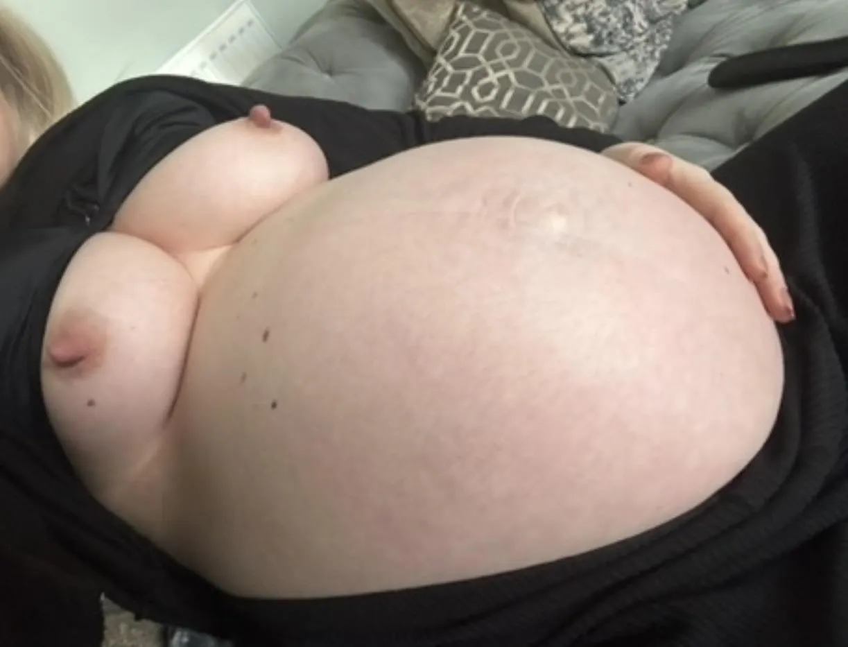 Sit next to me and rub my huge pregnant belly