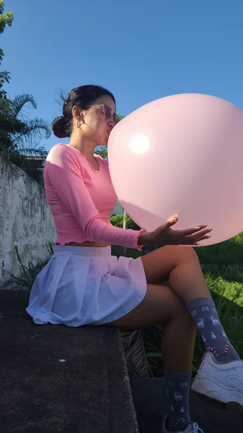 Inflating a large balloon outdoors