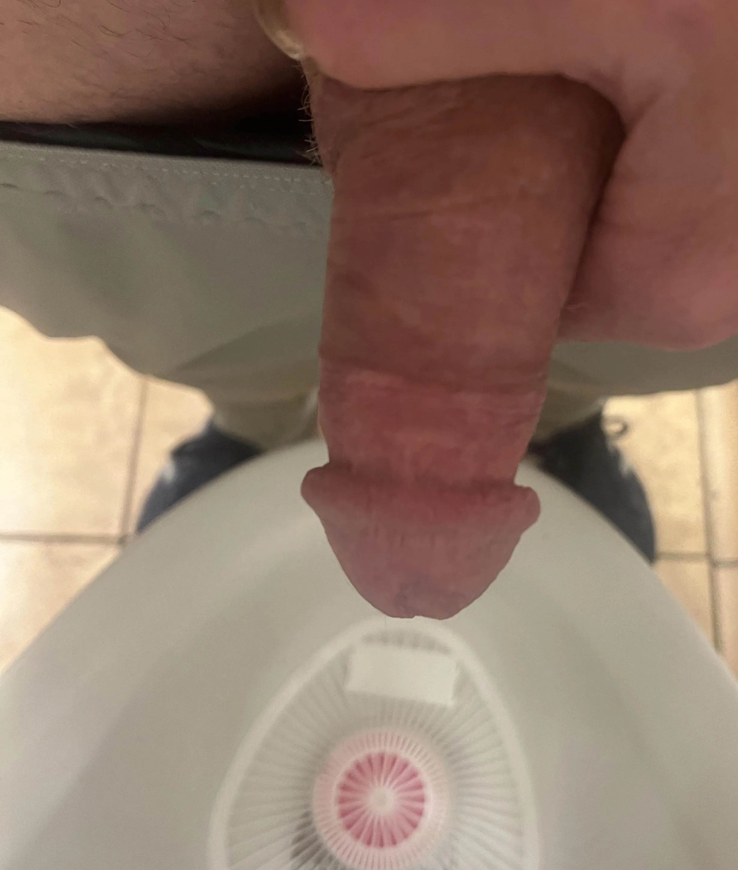 Pants down at the open urinal