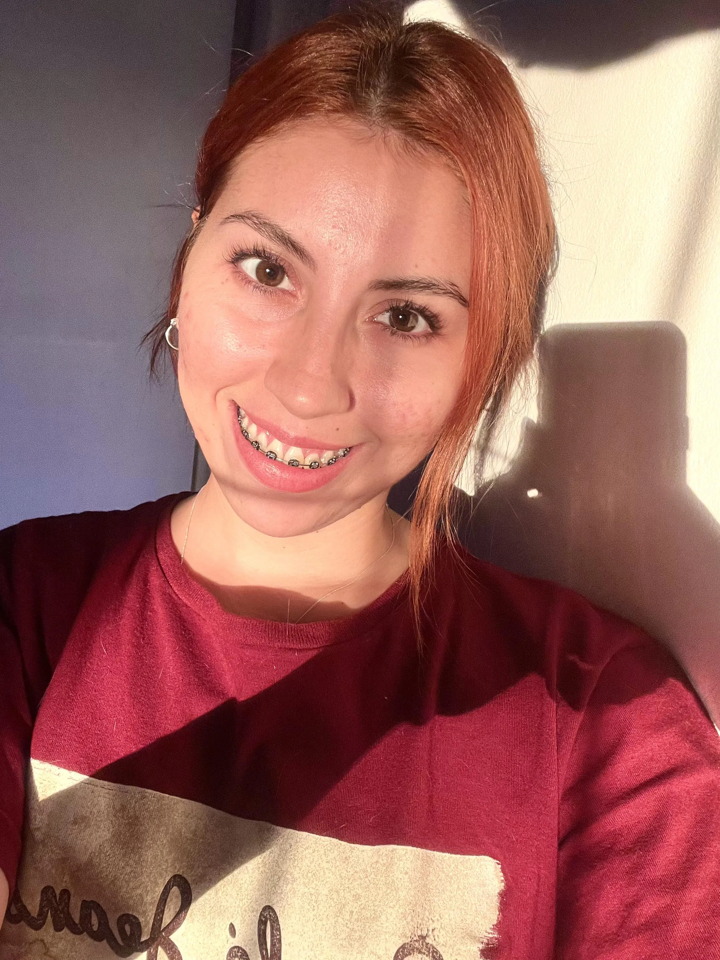 The sun makes my hair and braces stand out.