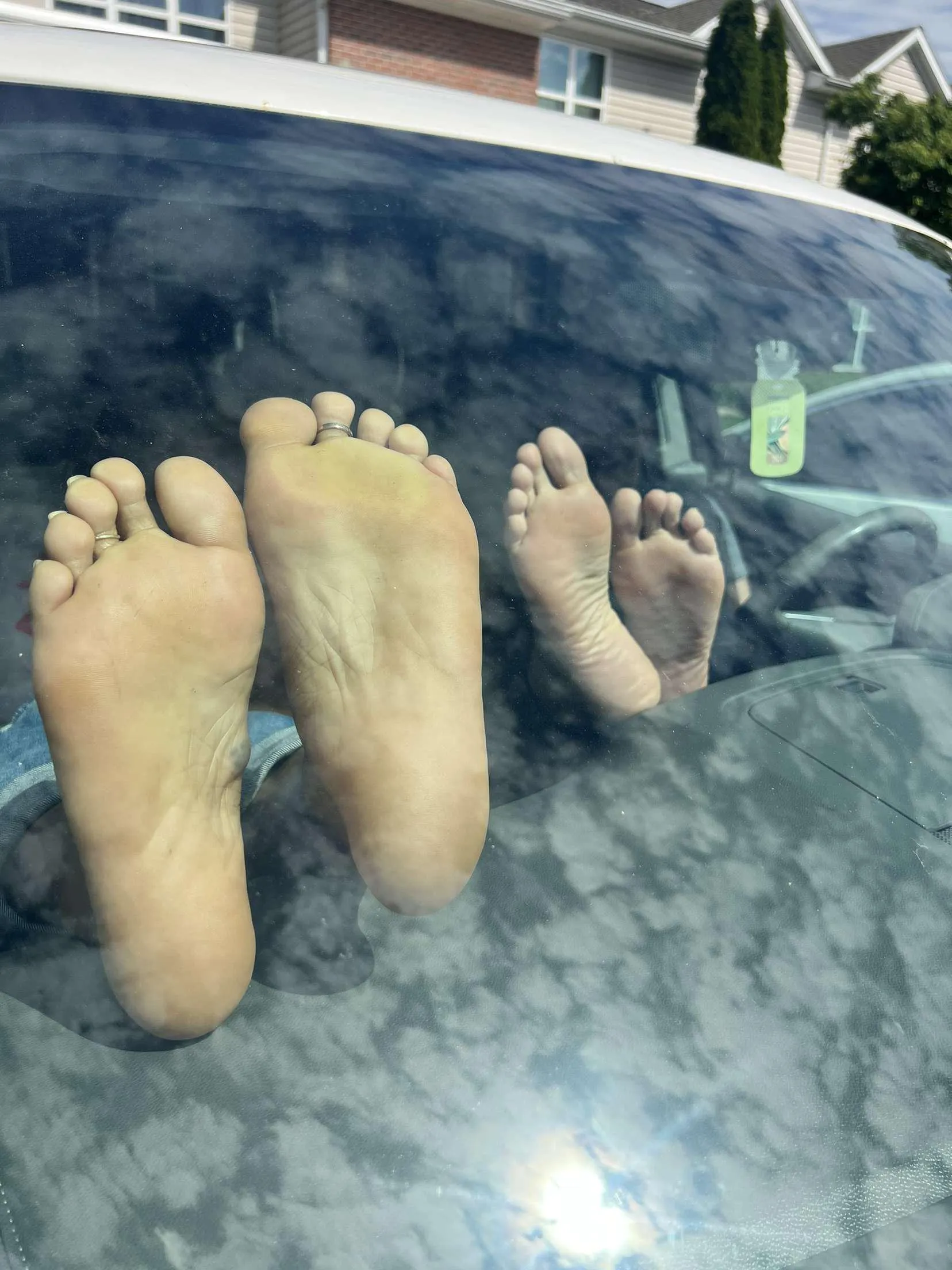 Wife and her friend barefoot in the car