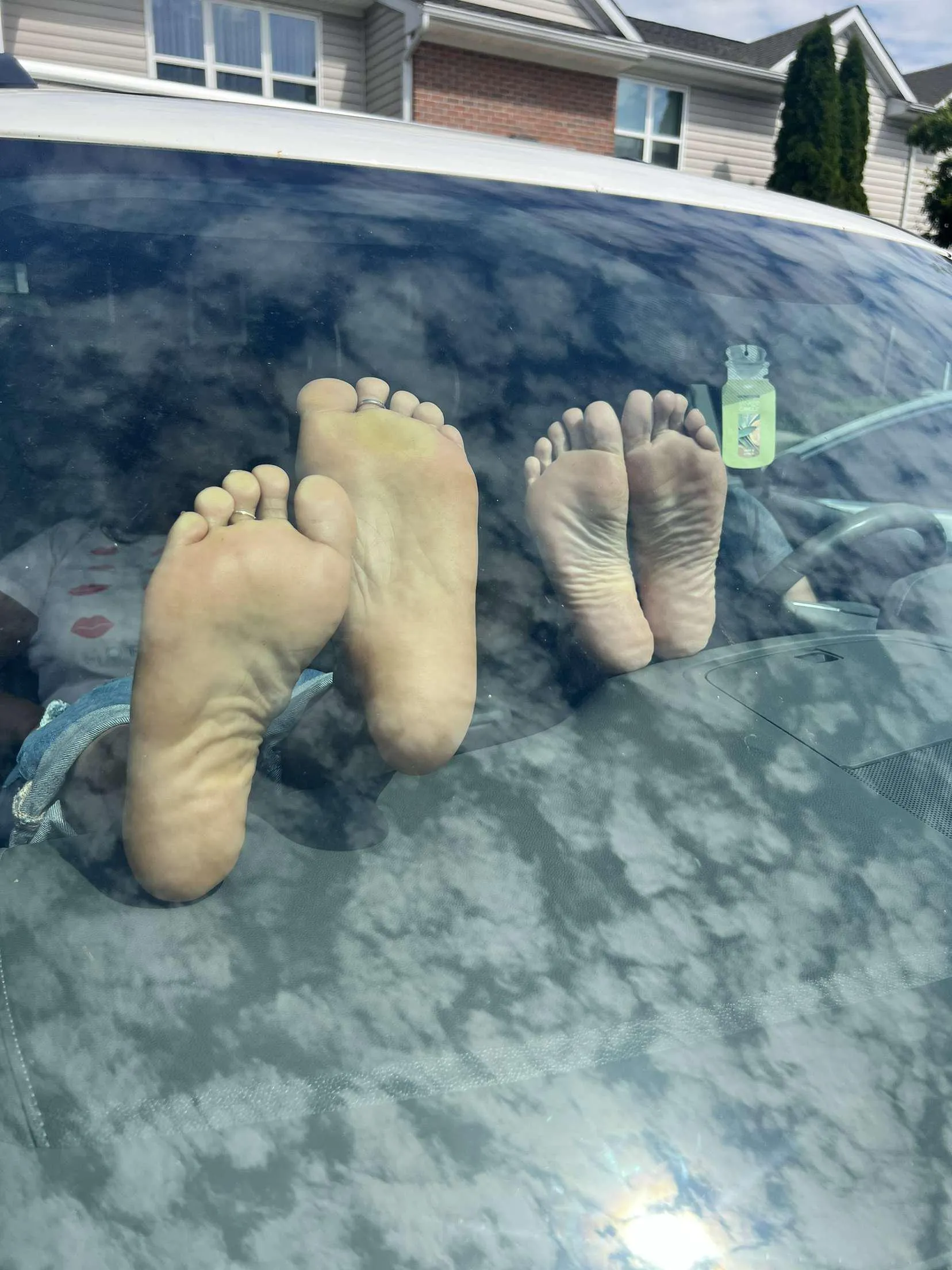 Wife and her sexy friend barefoot in the car