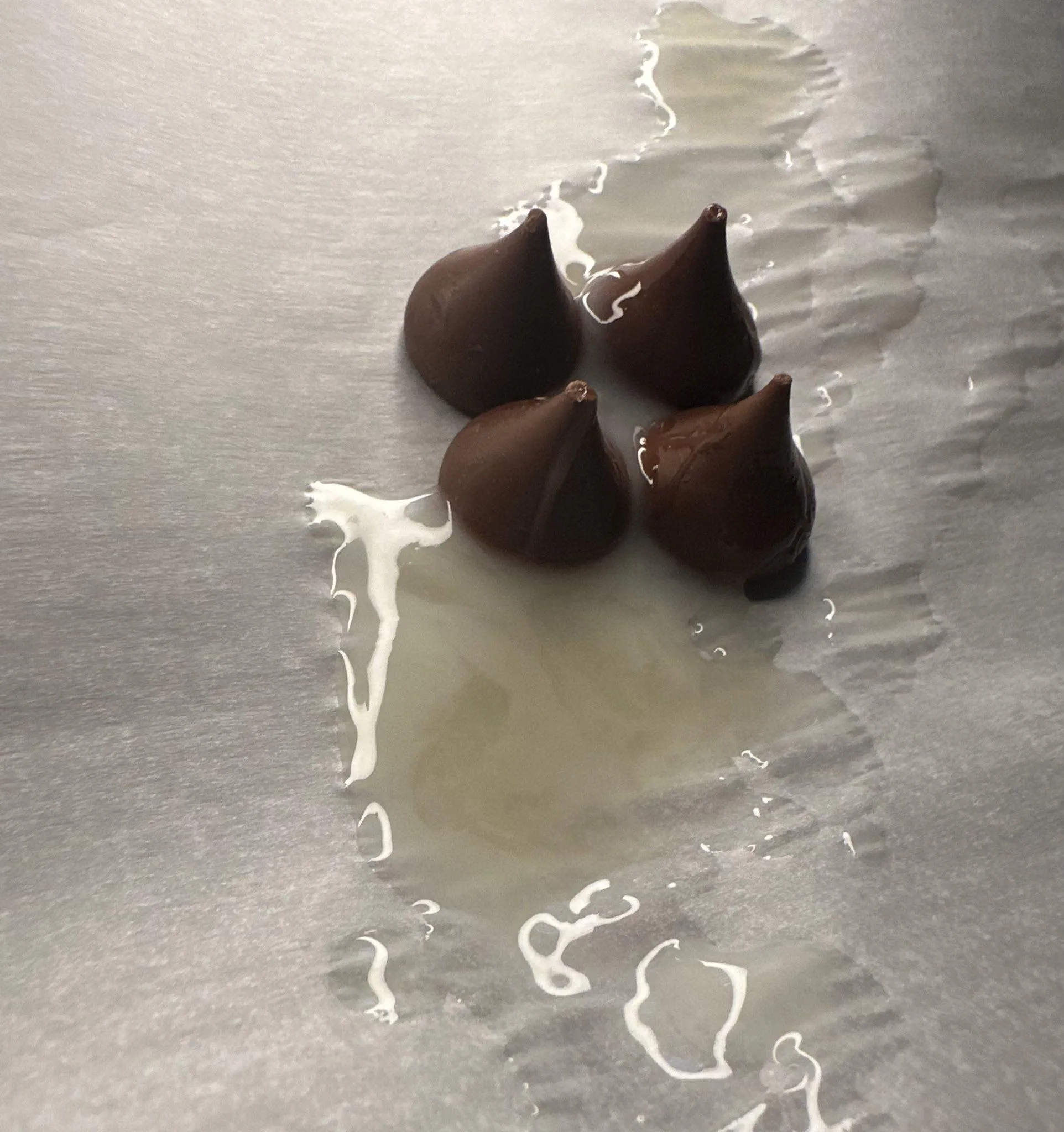White sauce on chocolate kisses