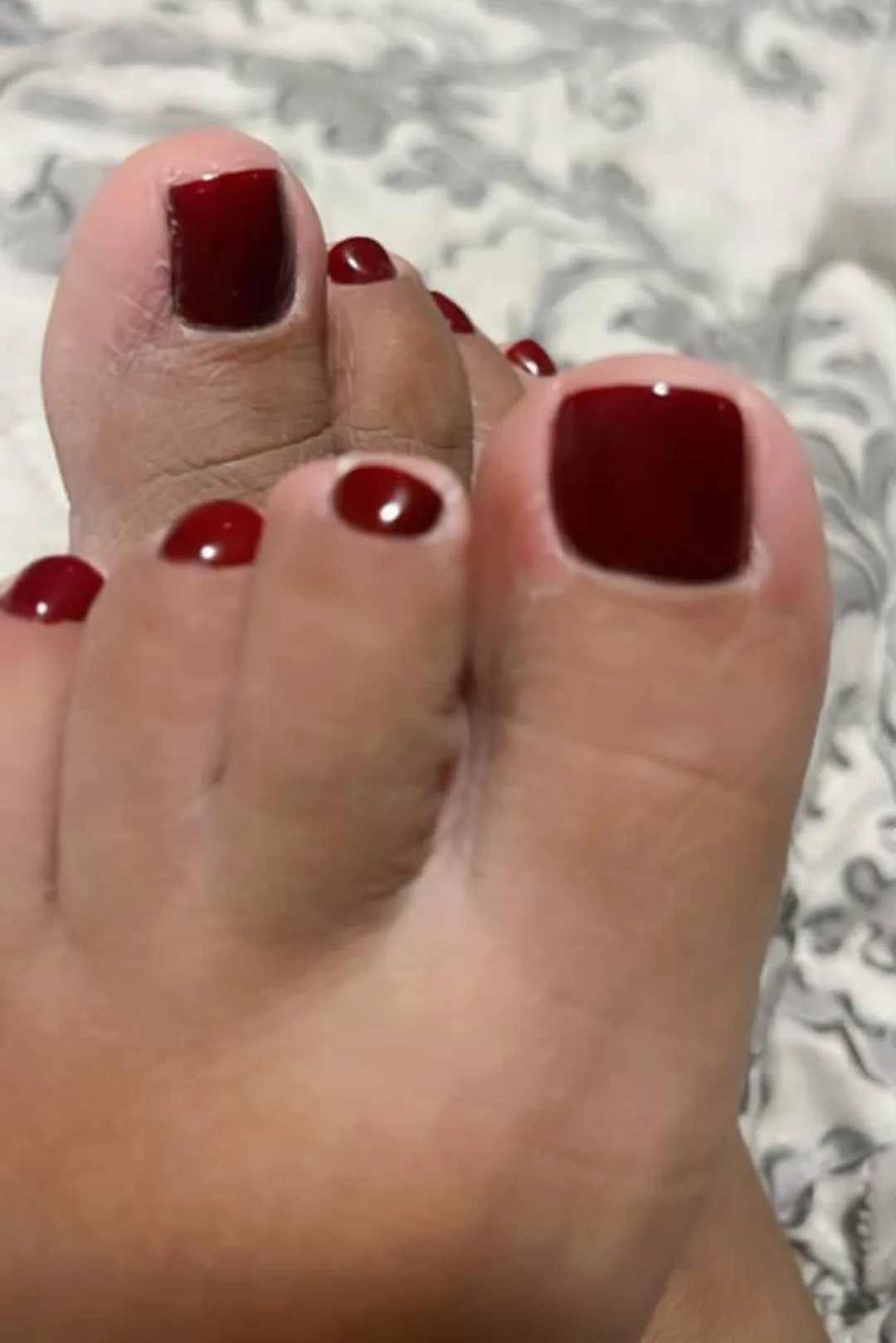 Tiny feet, with tiny red toes. THIS close. What are you doing with them