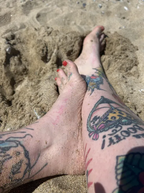 Sandy tattooed feet
