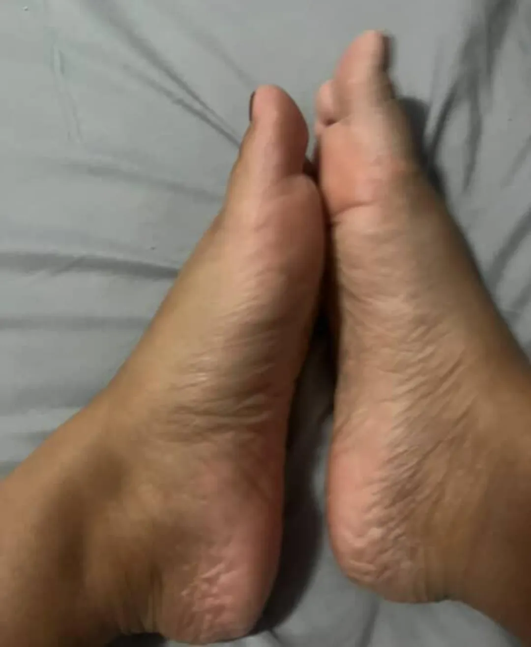 Just a couple of tiny wrinkly feet with soles pressed together. There's a gap for your fun
