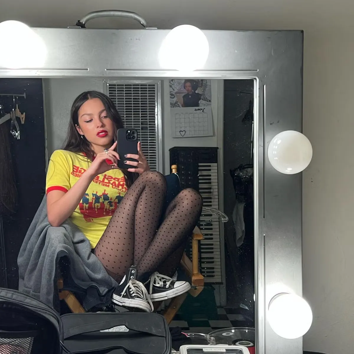 Olivia posted a mirror selfie sitting cross-legged in a makeup chair, May 27, 2023
