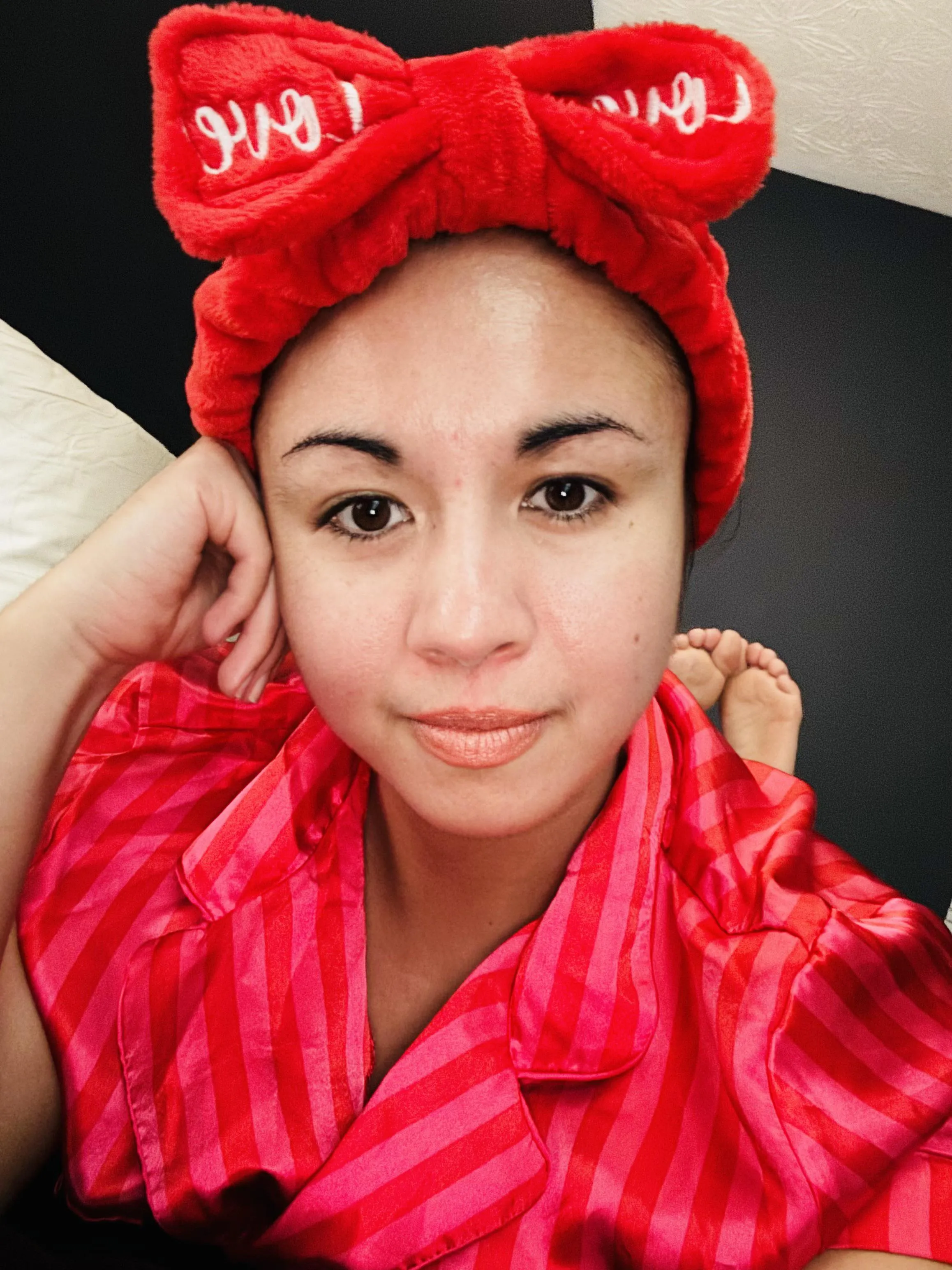 Fuzzy red headband with a bow.