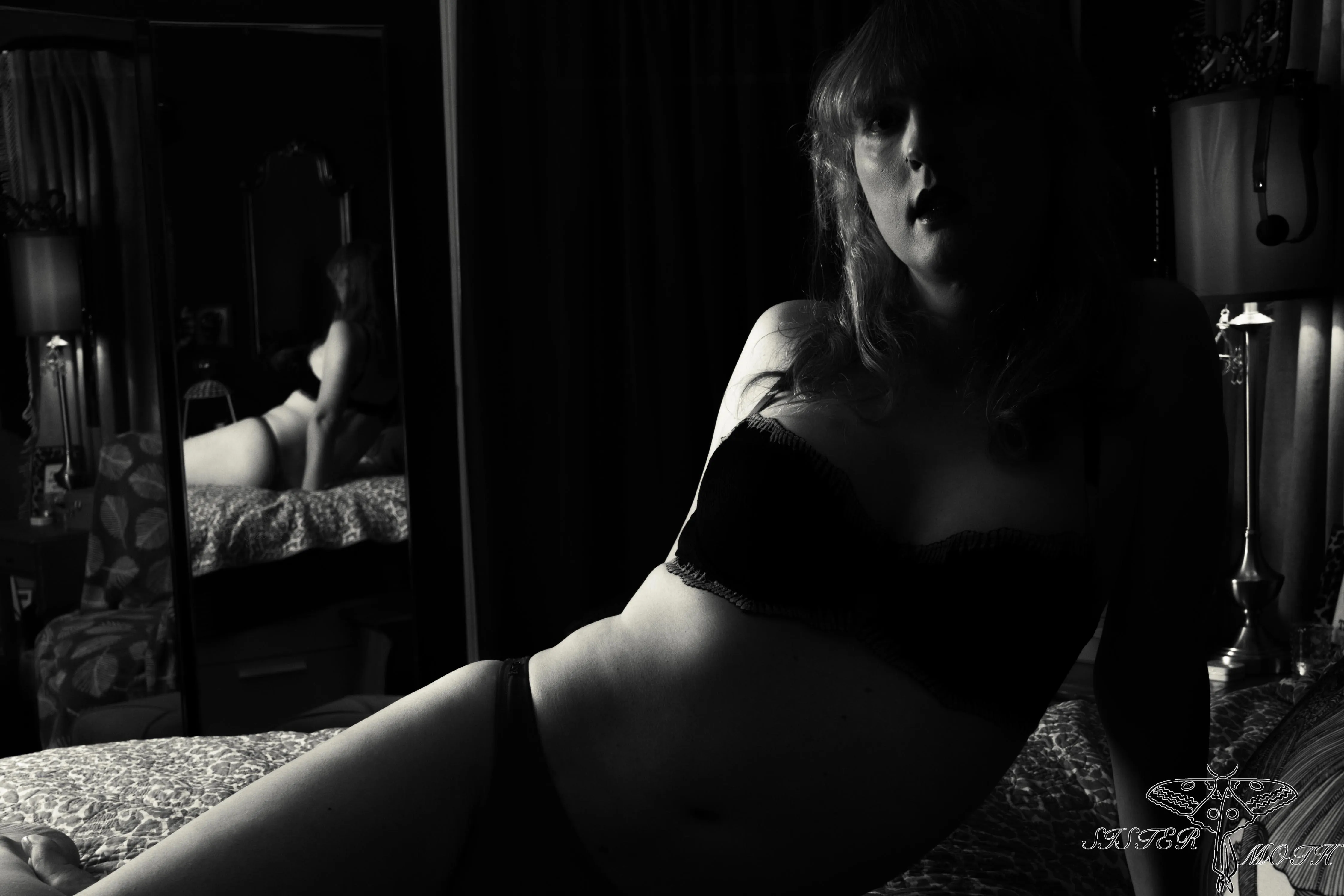 Shadows danced across her skin, as if night itself was caressing her curves