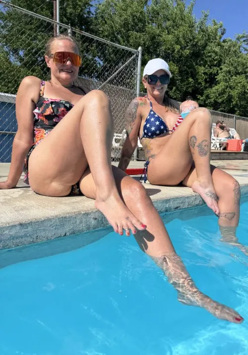 Two Milfs chilling poolside on a hot day