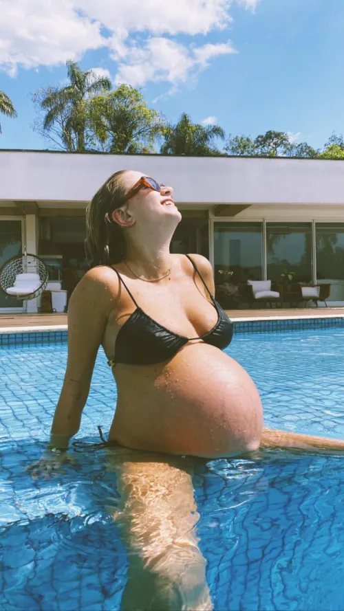 Pretty pregnant posing in the pool
