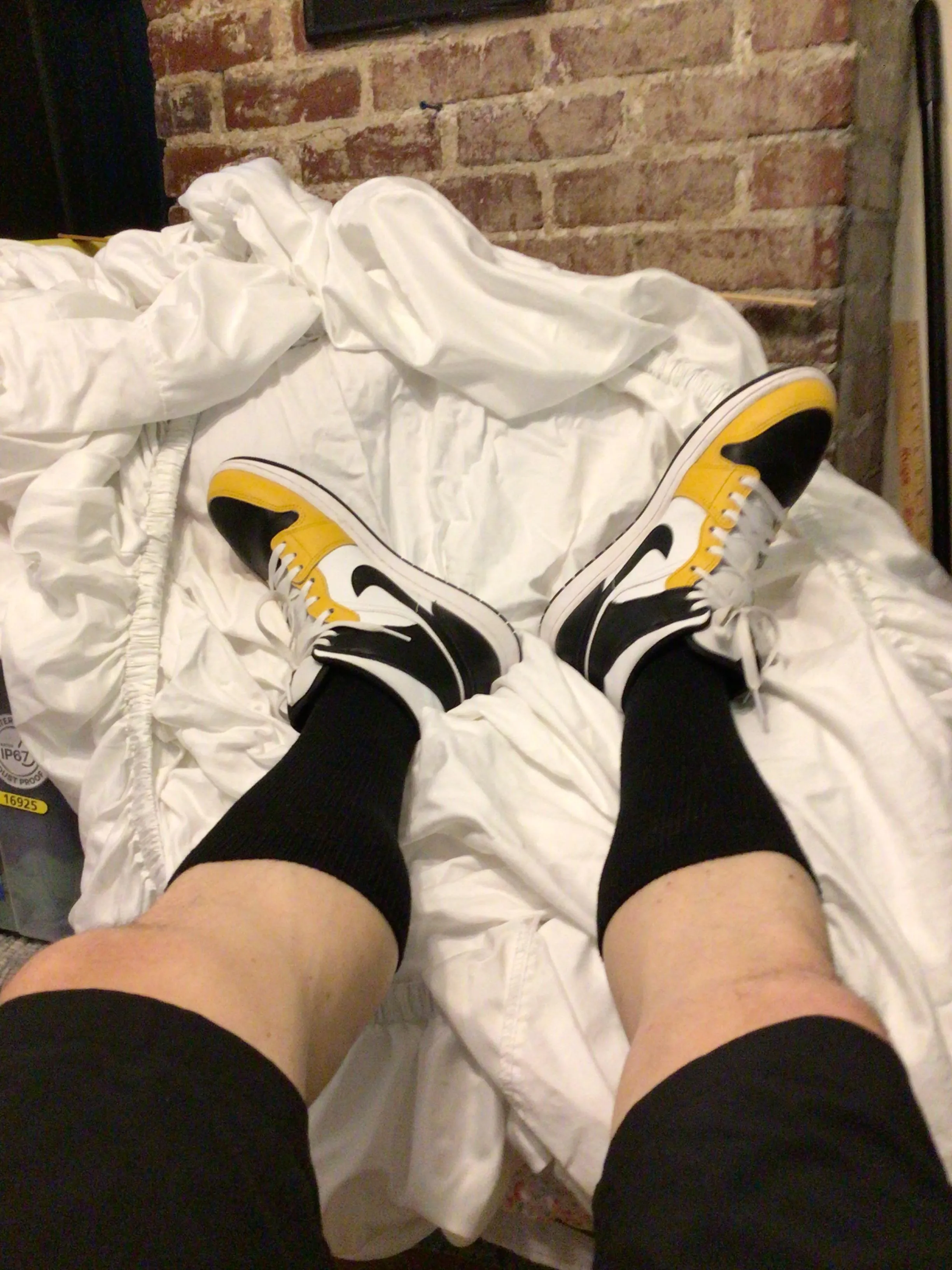 Almost Triple Black, Air Jordans Mid 1s in black and gold, Hanes black crews match up with Nike black shorts.