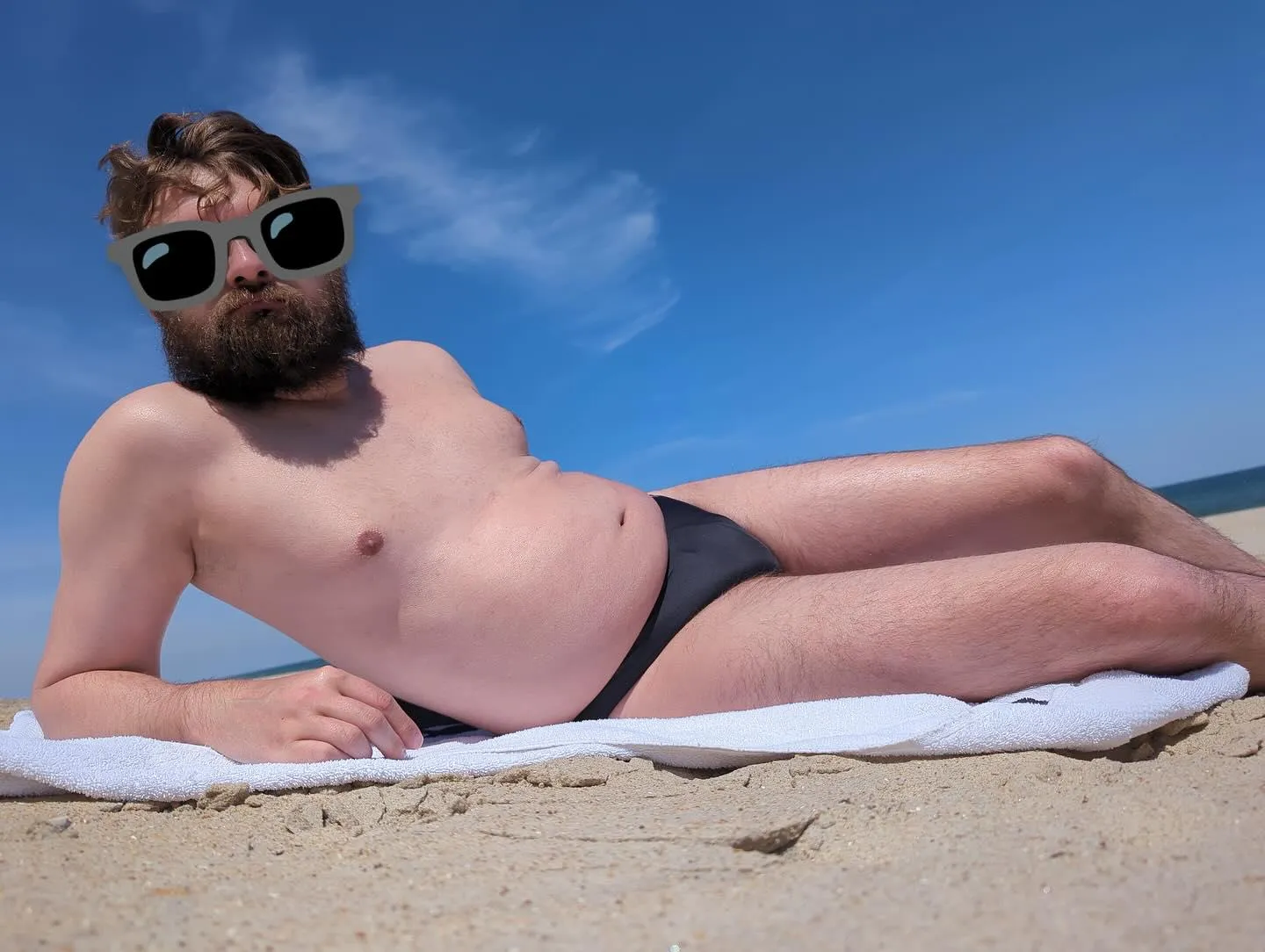 striking a pose in [m]y speedo on the beach