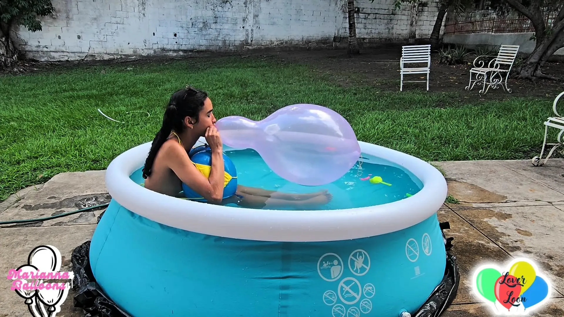 Inflating balloons in a swimsuit outdoors