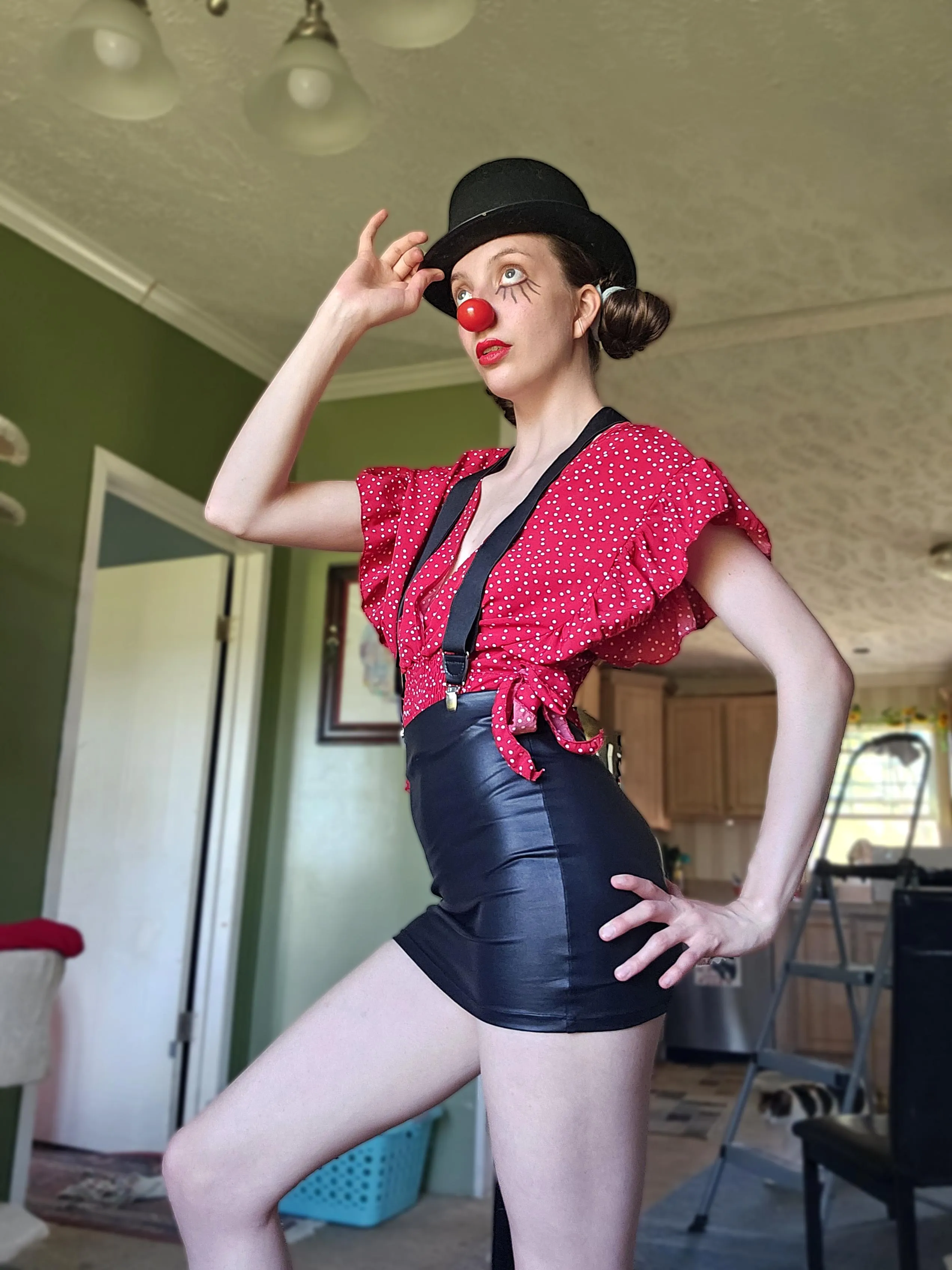 Clown with suspenders and a tight leather skirt