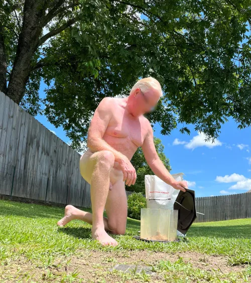 Filling the bird feeder. Taking care of our feathered friends