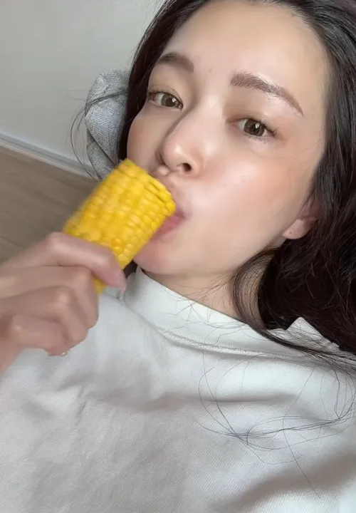 Mary eating some corn.