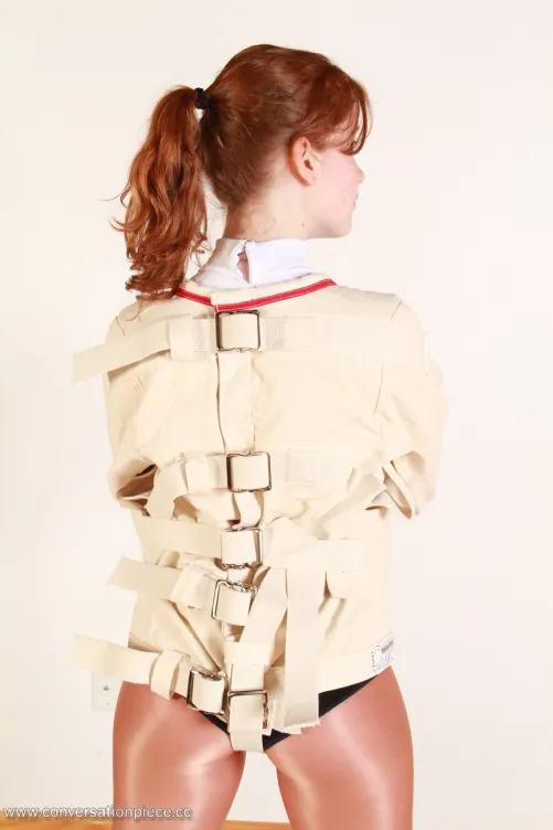 Ginger Cynthia in restrained in a straitjacket