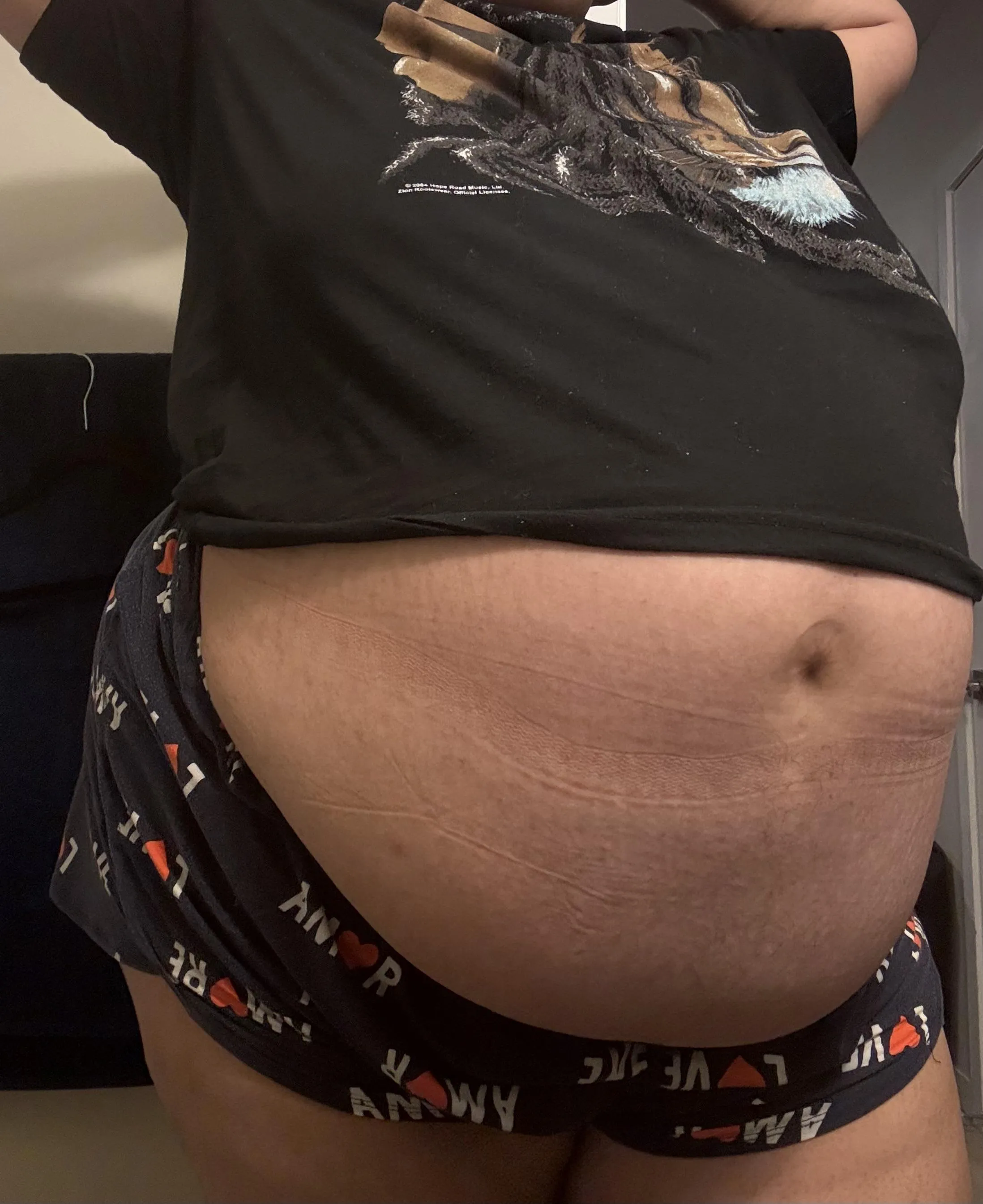 This preggo belly button is hanging on by a thread!