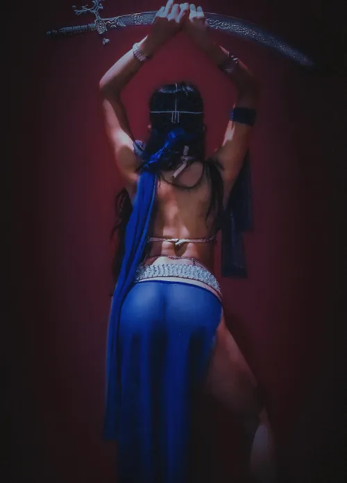 Not a captive. A huntress draped in blue and ready to strike.