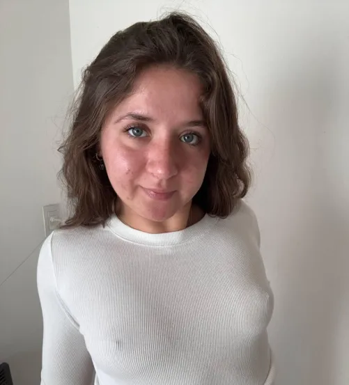 The early morning face of a woman: messy hair, bare face, perky nips