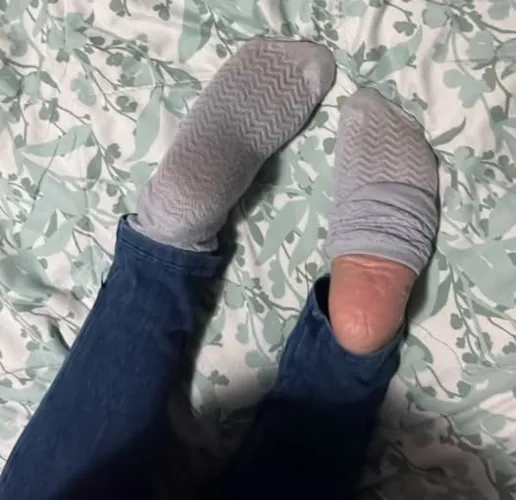 What are you doing with these socked feet. Sniff, taste or peel