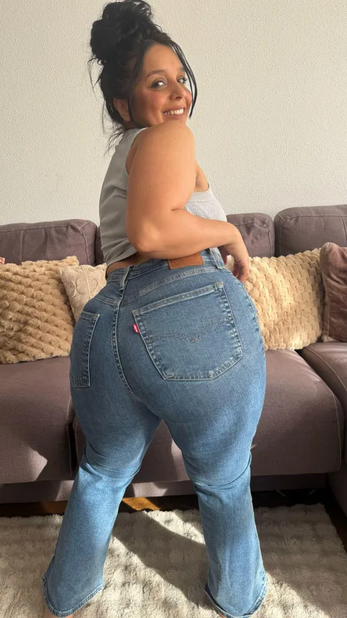 Tanned curves in snug Levis sparking sassy heat this season ruling the seaside scene