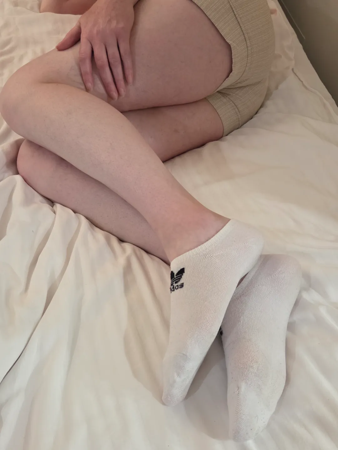 Laying down, waiting for you, wearing the sexiest white socks just for you.