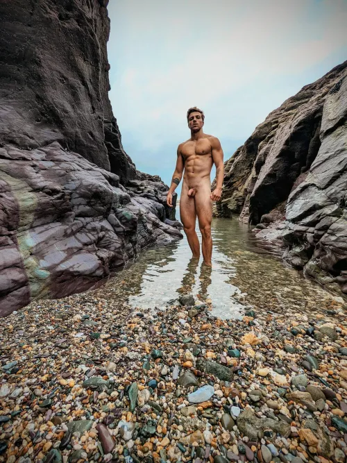 Strong and muscular, naked in the ocean