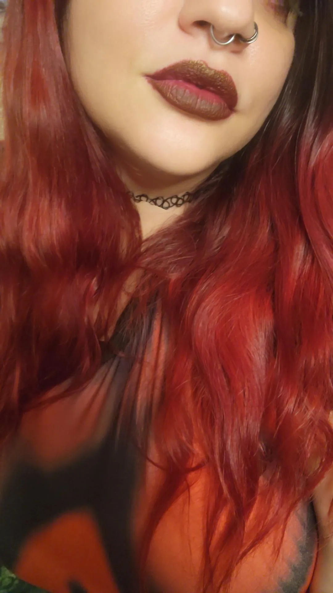 A redhead wearing dark red lipstick